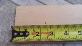 Plywood drilling jig marked for the new door knob