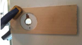 Clamp the jig to the door with the reference edge lined up on the edge of the door.